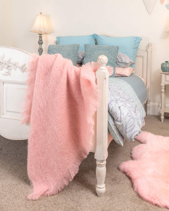 Dusk pink mohair throw in a bedroom