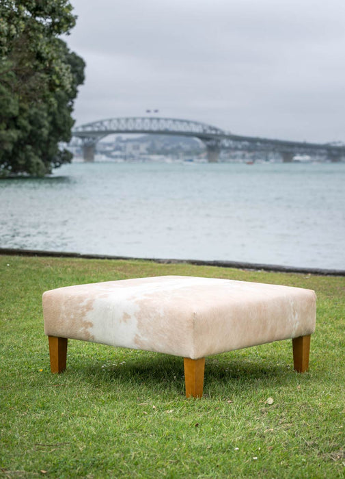 Square cowhide ottoman in beige and white cowhide