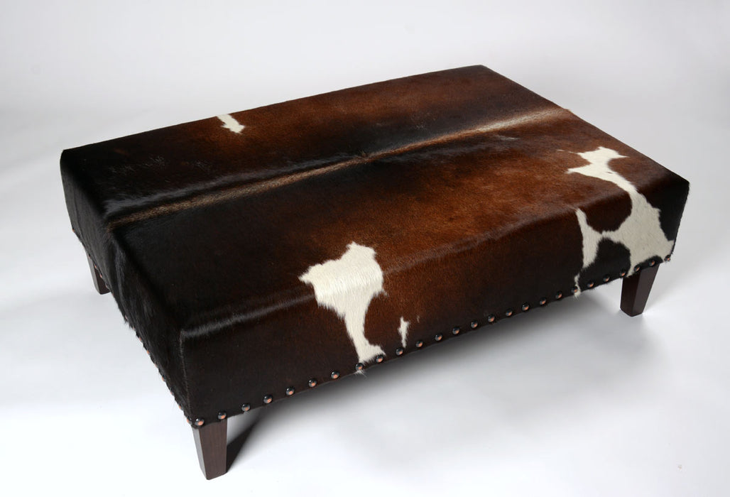 NZ cowhide ottoman copper studs
