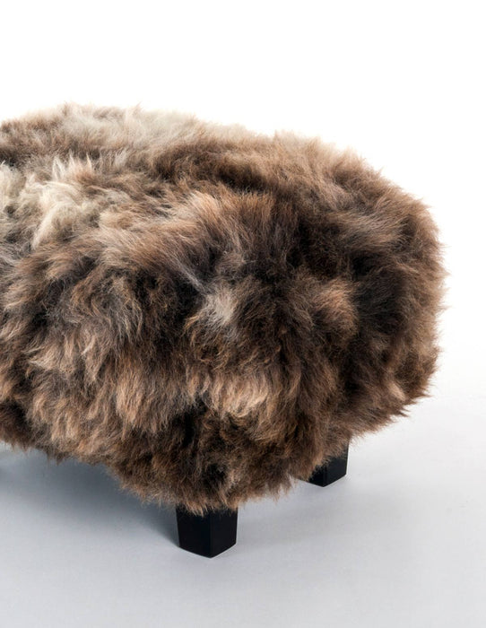 A cute chocolate wool sheepskin footstool