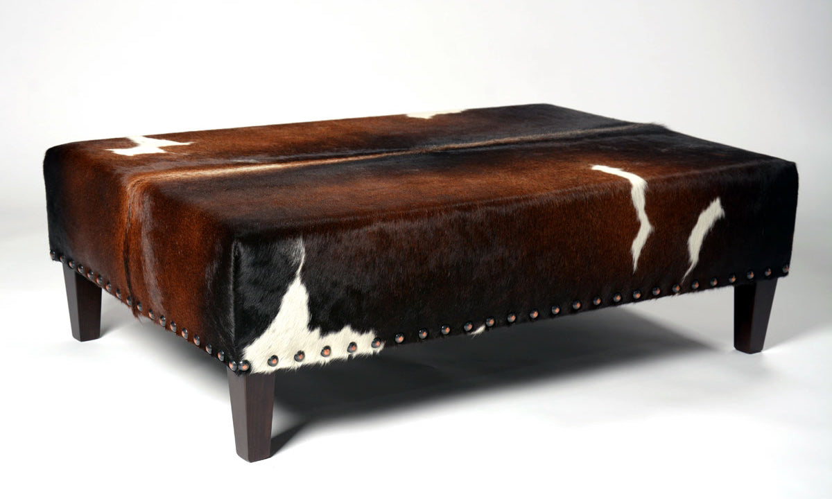 Cowhide ottoman with studs