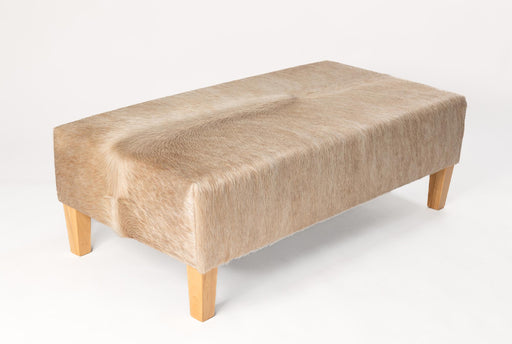 Beige cowhide ottoman with light wood legs