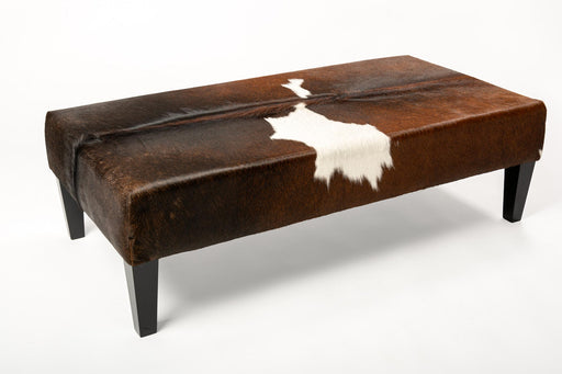 Reddish brown & white cowhide ottoman with wood legs 120cm x 60cm x 38cm tall.