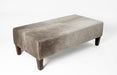 Grey cowhide ottoman with red brown wood legs