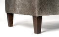 Grey cowhide ottoman with red brown wood leg detail