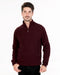 Man wearing a burgundy pullover with a quarter zip on a white background