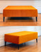 Bright orange velvet ottoman