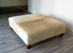 Square cowhide ottoman in beige cowhide