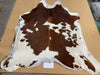 Chestnut brown and white cowhide rug by Gorgeous Creatures