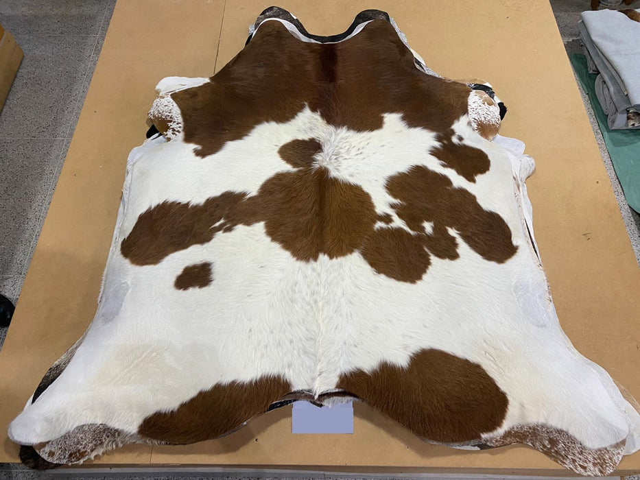 Chestnut brown & white cowhide rug