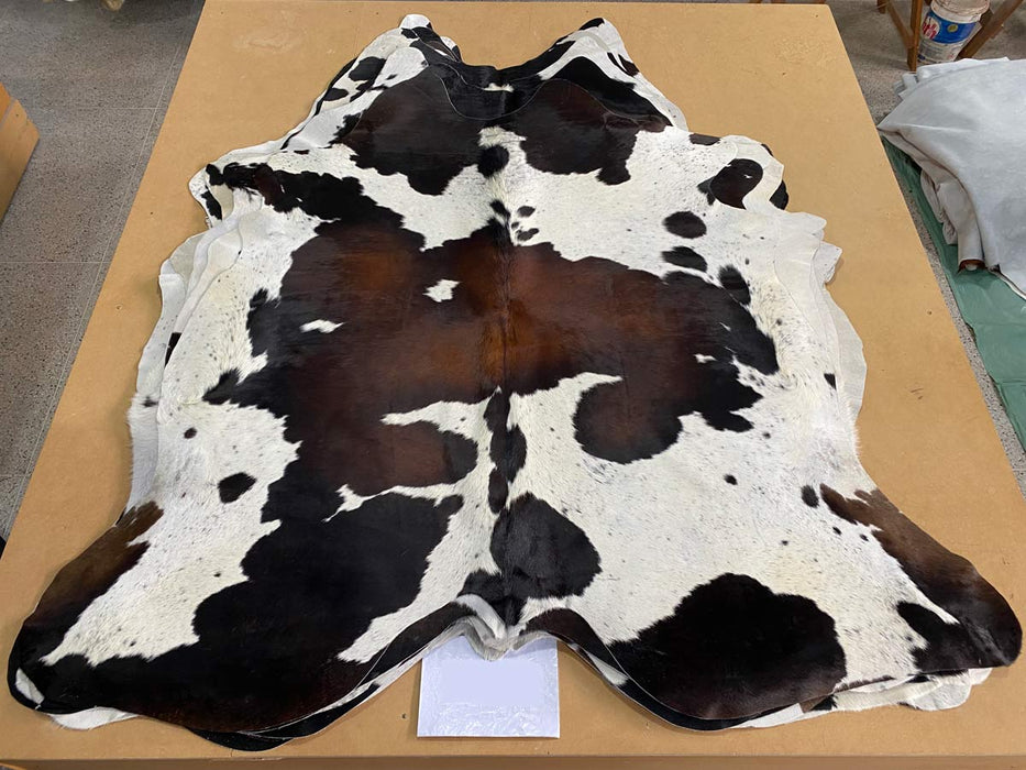 Classic chocolate brown and white cowhide rug