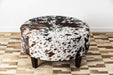 Speckled round cowhide ottoman with square legs