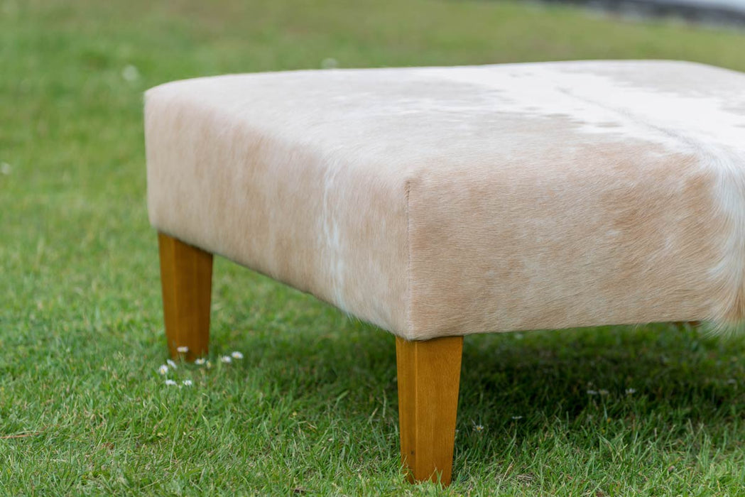 Square cowhide ottoman in beige and white cowhide