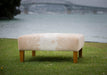 Square cowhide ottoman in beige and white cowhide