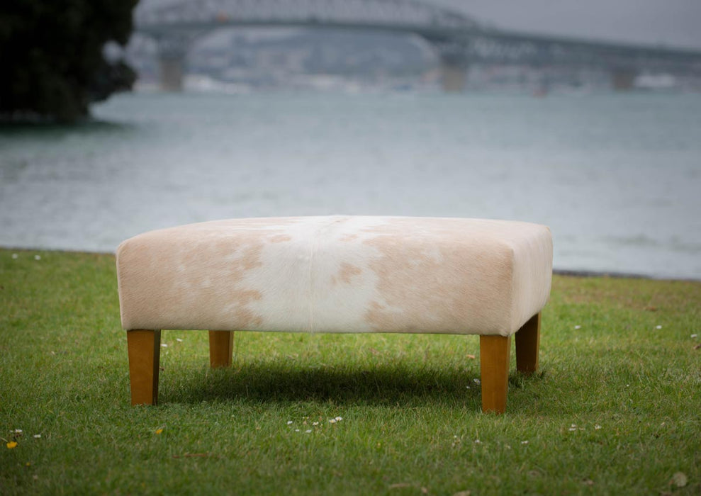 Square cowhide ottoman in beige and white cowhide