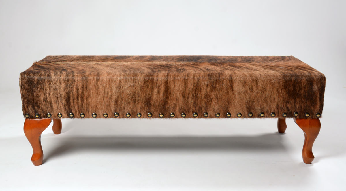 Cowhide ottoman with wood cabriole legs