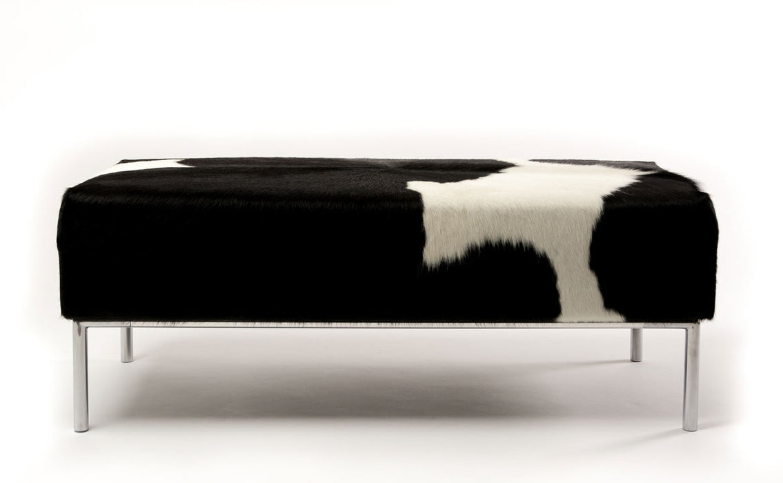 Black & white cowhide ottoman with metal feature rail base 110cm x 50cm x 40cm tall.