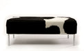 Black & white cowhide ottoman with metal feature rail base 110cm x 50cm x 40cm tall.