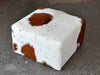 Square ottoman in brown and white cowhide