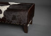 Long bench ottoman in cowhide with studs