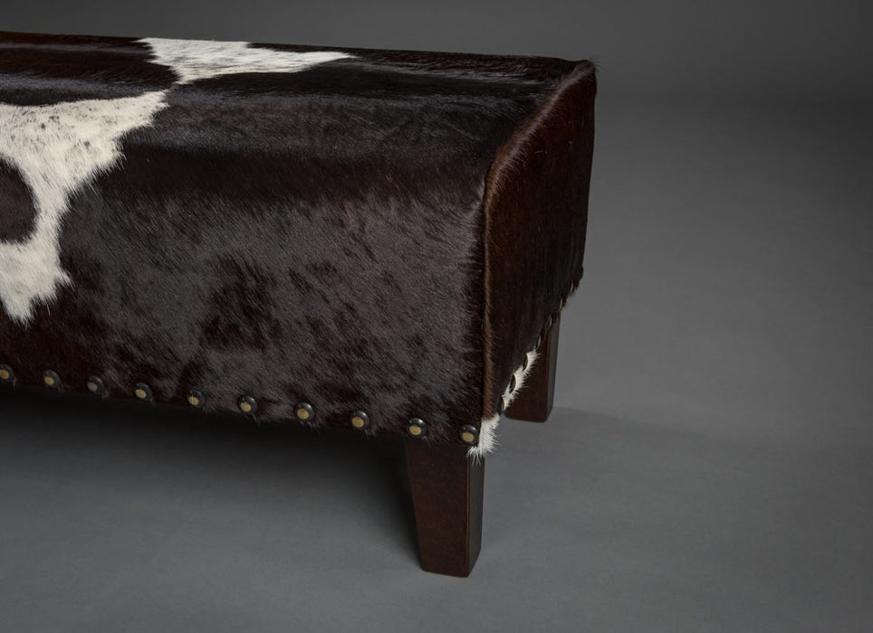 Long bench ottoman in cowhide with studs