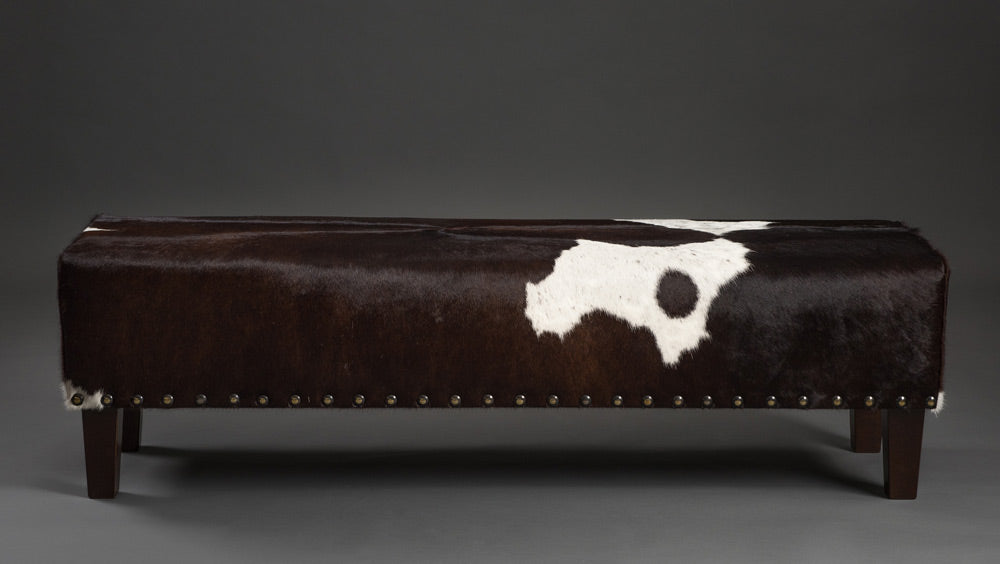 Long bench ottoman in cowhide with studs