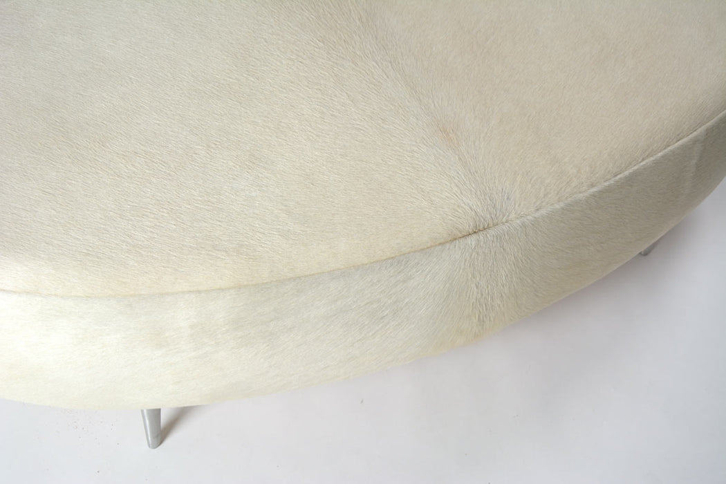 Off-white cowhide oval ottoman
