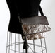 Brown and white cowhide handbag