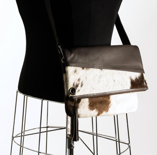 Brown and white cowhide handbag