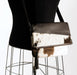 Brown and white cowhide handbag