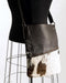 Brown and white cowhide handbag