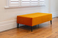 Bright orange velvet ottoman