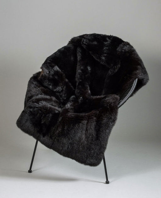 Warm Black Possum Fur Blanket NZ on a chair