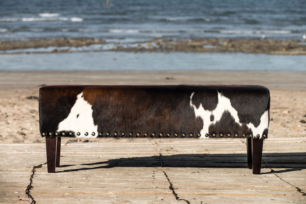 Long bench ottoman in cowhide with studs