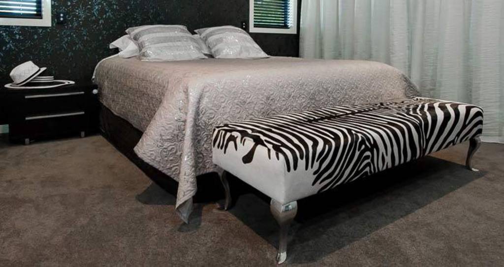 End of bed zebra print cowhide ottoman